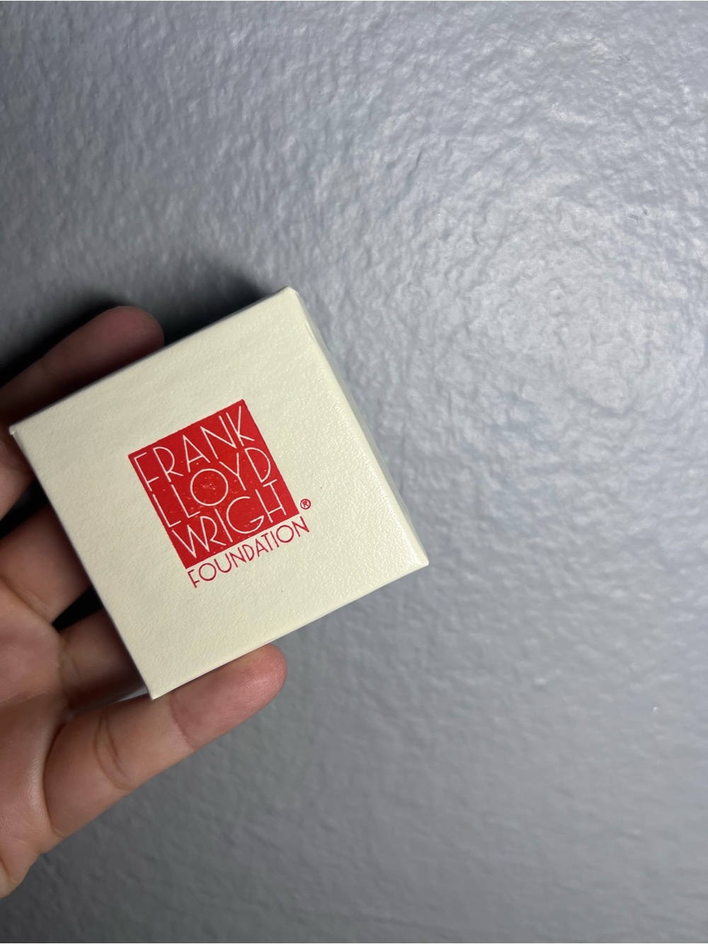 Frank Lloyd Wright Foundation membership pin features a vibrant red enamel squar